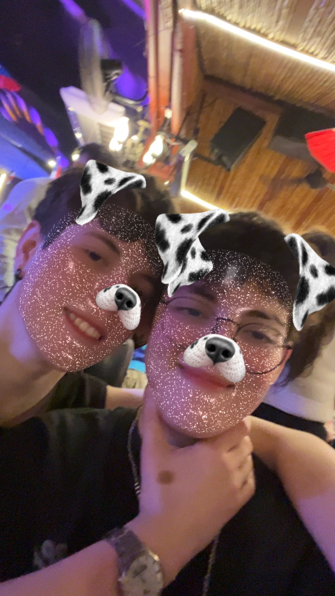 Selfie de los dos muy cerquita, con luces cálidas y filtro de perrito